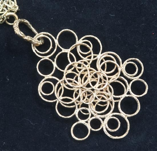 A gold chain and multi ring pendant.